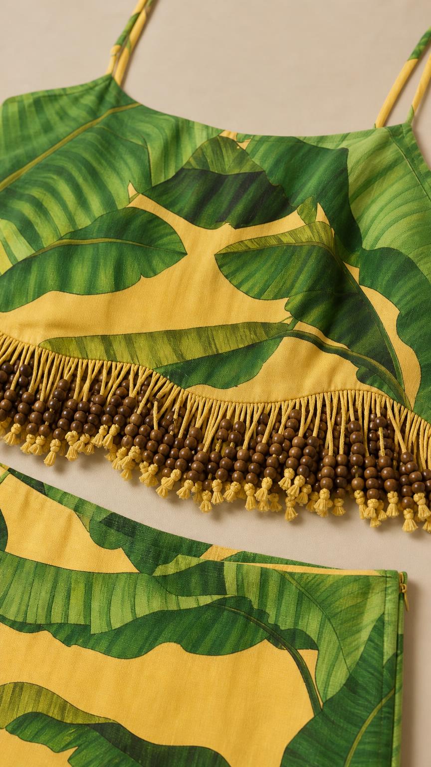 Close-up detail of the yellow banana leaf fabric and beaded fringe hem