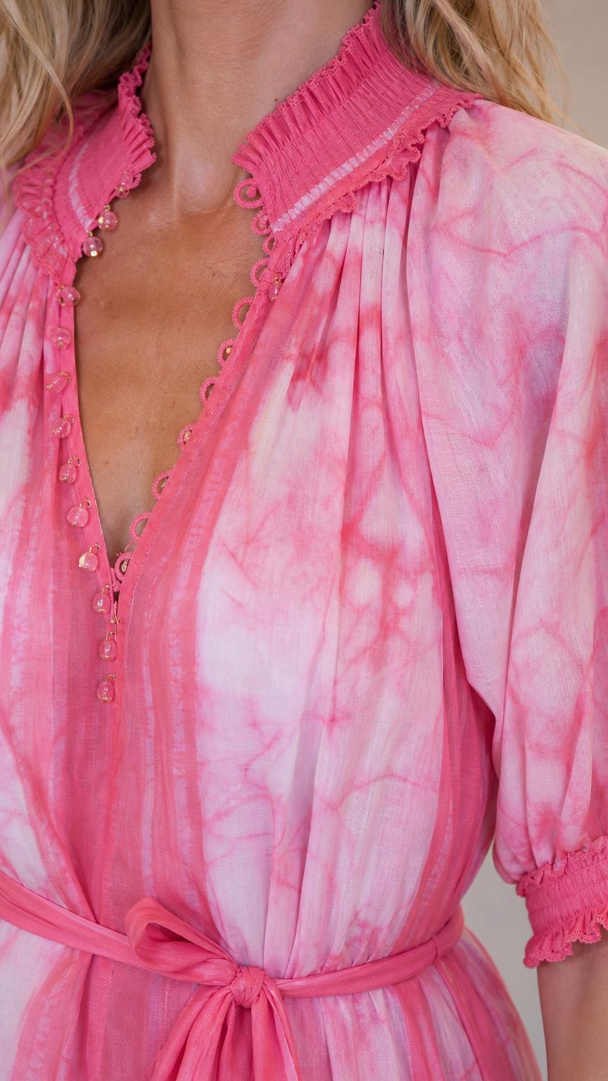 Close up of smocked ruffle neckline and button detail