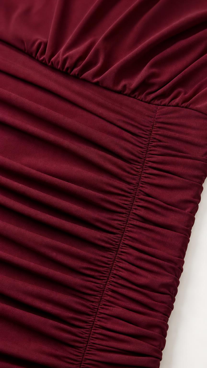 Close-up of texture and ruching detail on burgundy fabric