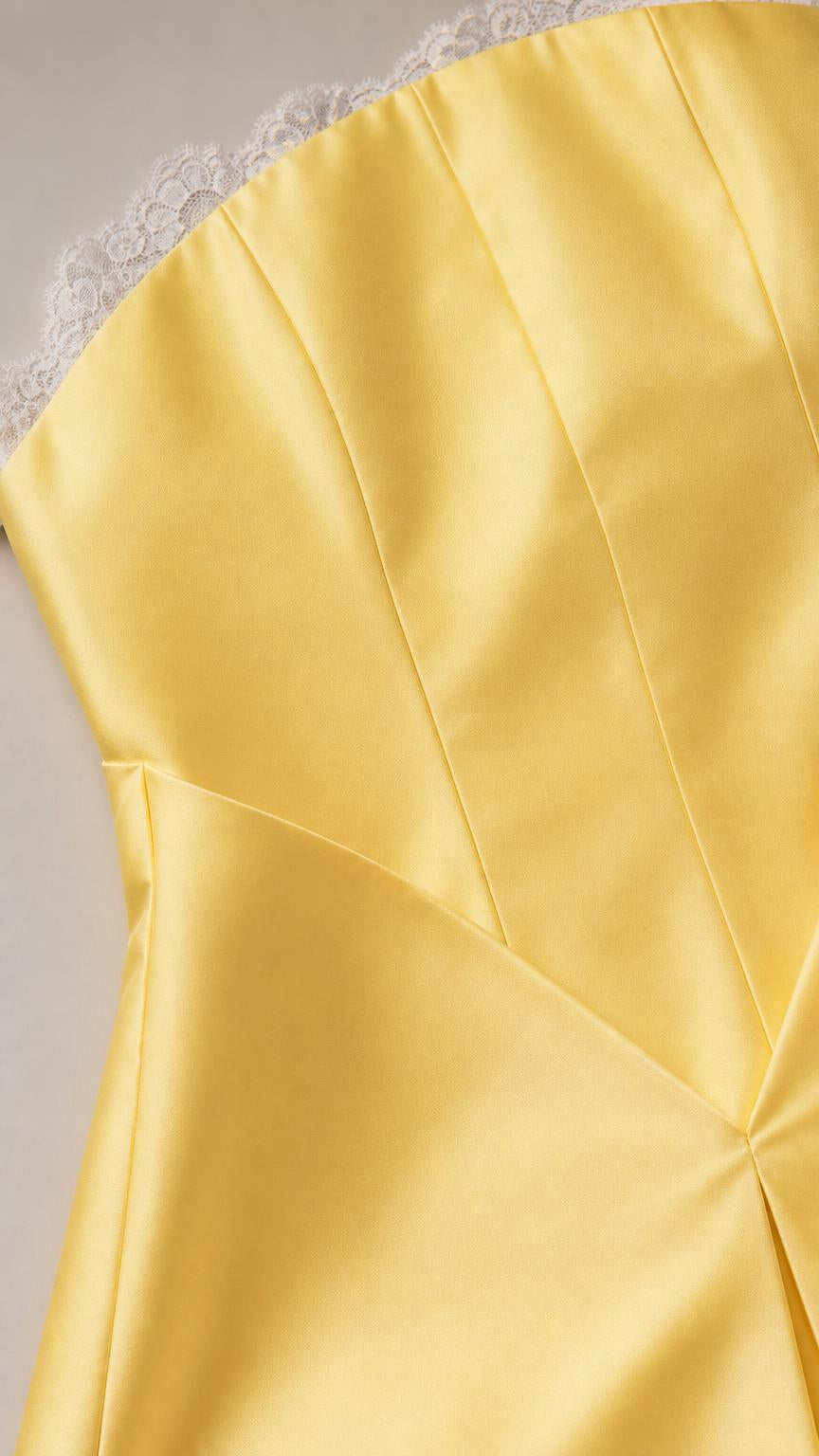 Close-up of lace trim and satin bodice seaming on yellow dress