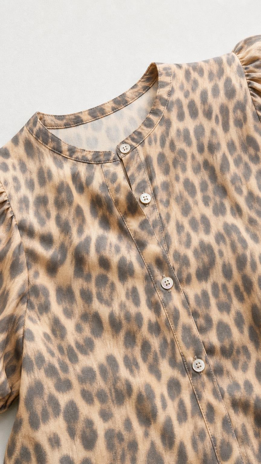 Close-up detail of button-up top collar and fabric pattern