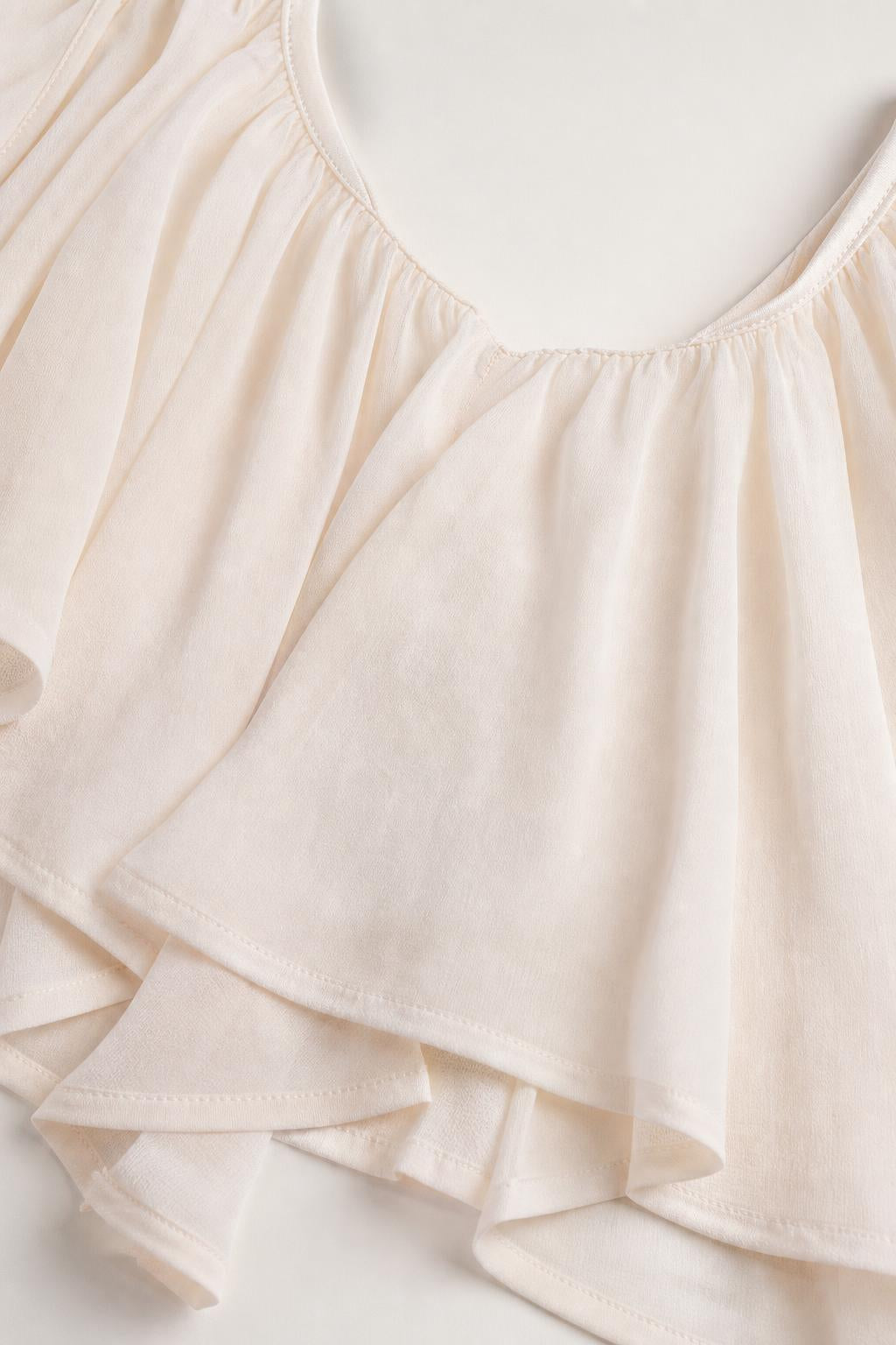 Close-up detail of soft fabric and ruffle trim