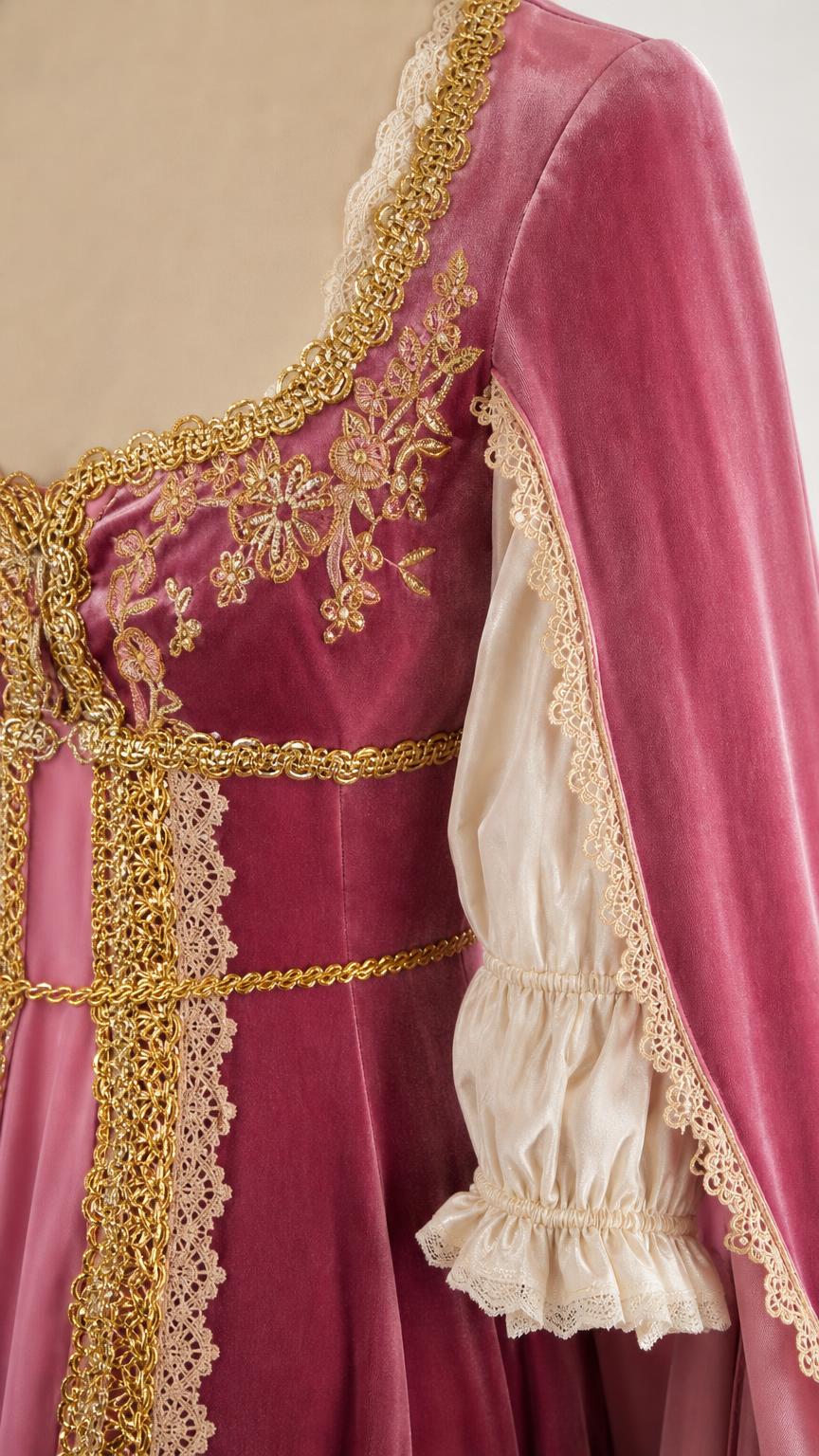 Close-up of gold embroidery and lace sleeve details
