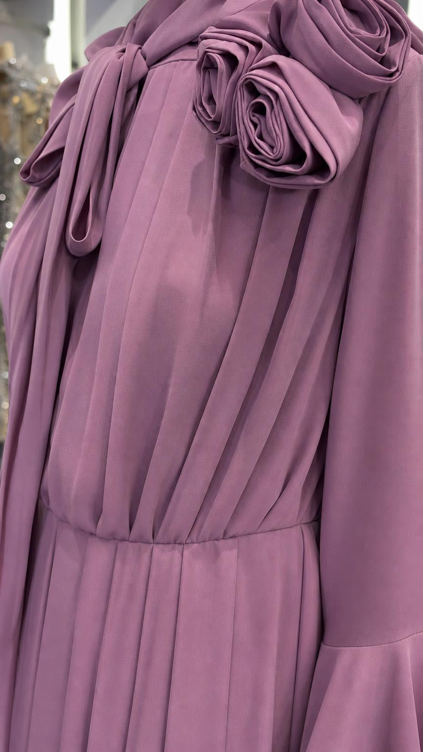 Close-up detail of 3D rosette and tie-neck on lavender dress