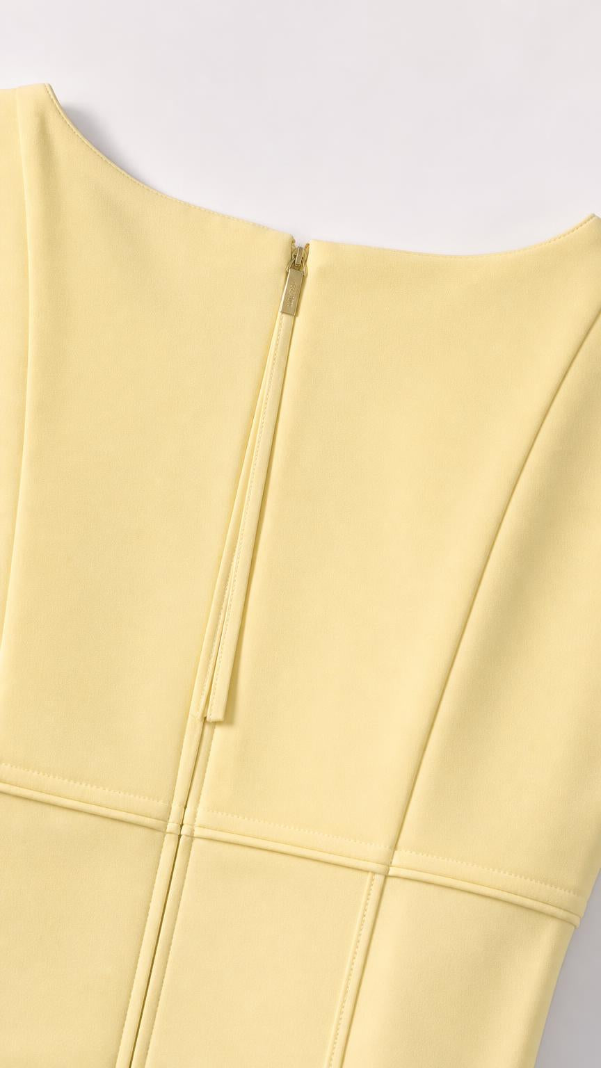Close-up of yellow dress back zipper and panel seaming details