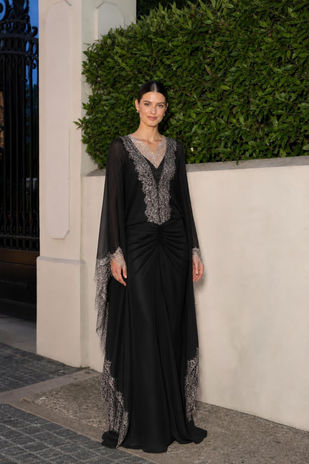 Model wearing black lace trim cape sleeve maxi dress