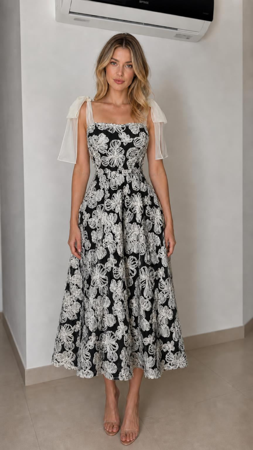 Front view of black floral applique midi dress