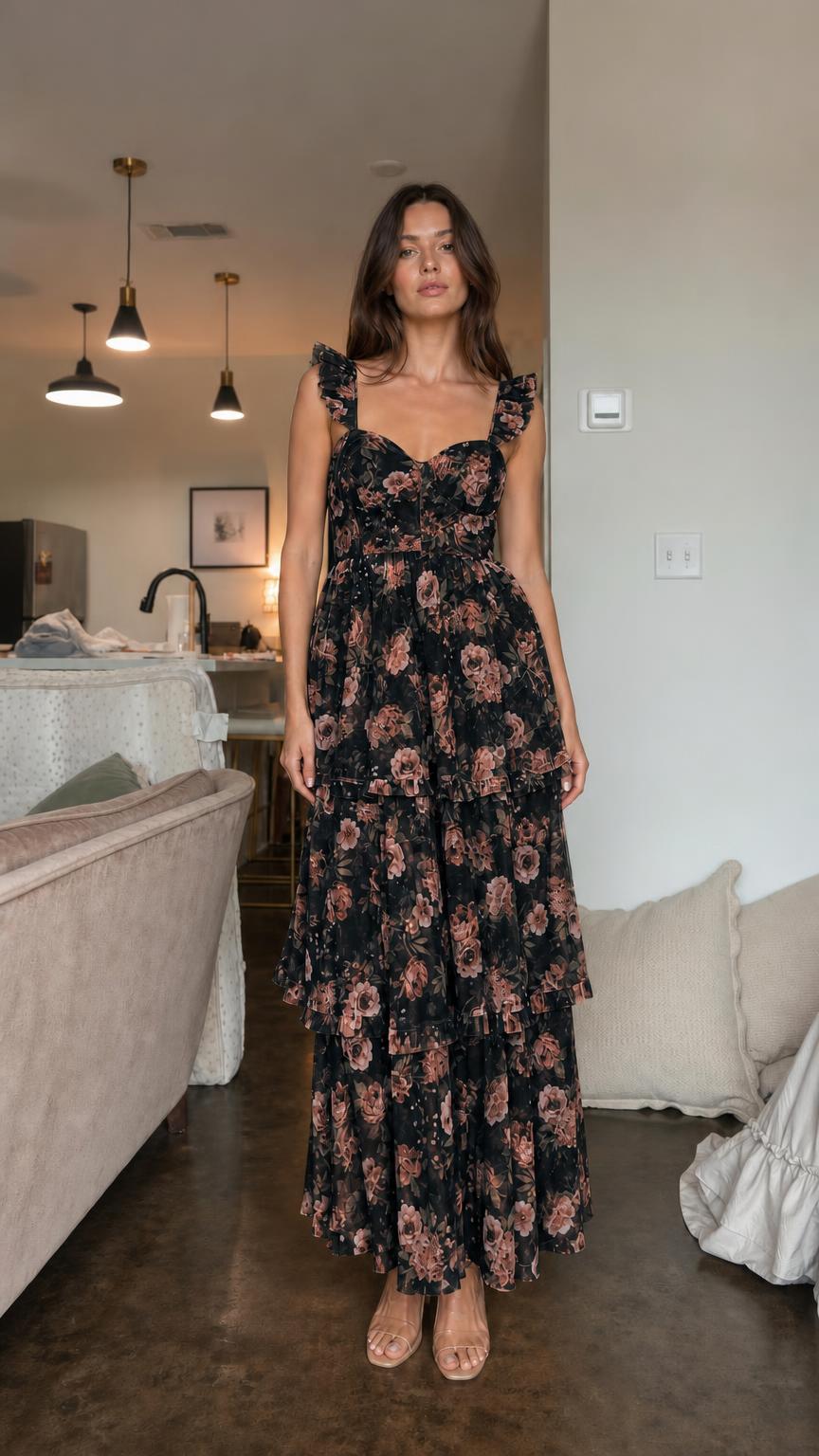 Front view of model wearing black floral ruffle tiered maxi dress
