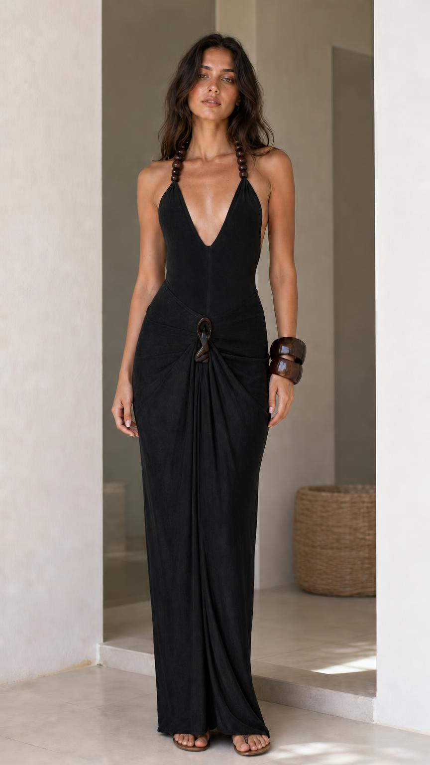 Model wearing black halter maxi dress