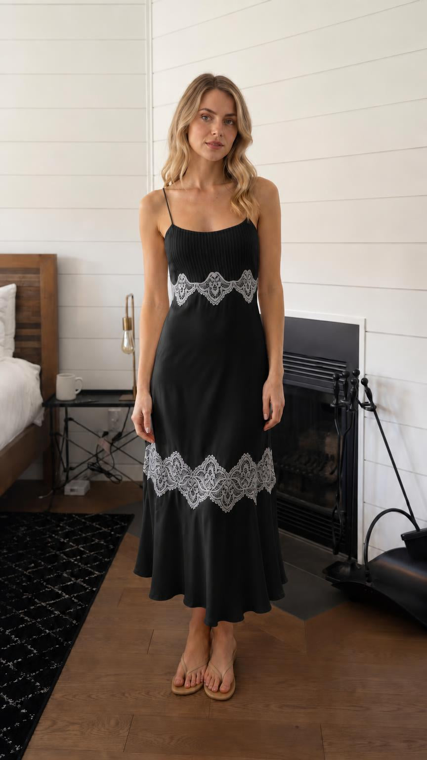 Woman wearing black lace trim pleated slip midi dress