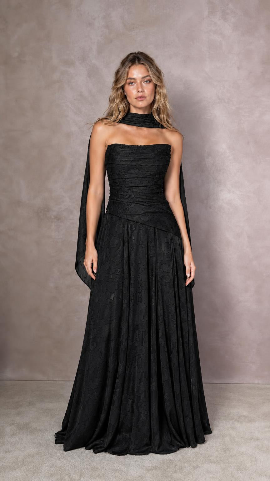 Front view of model wearing black strapless evening dress