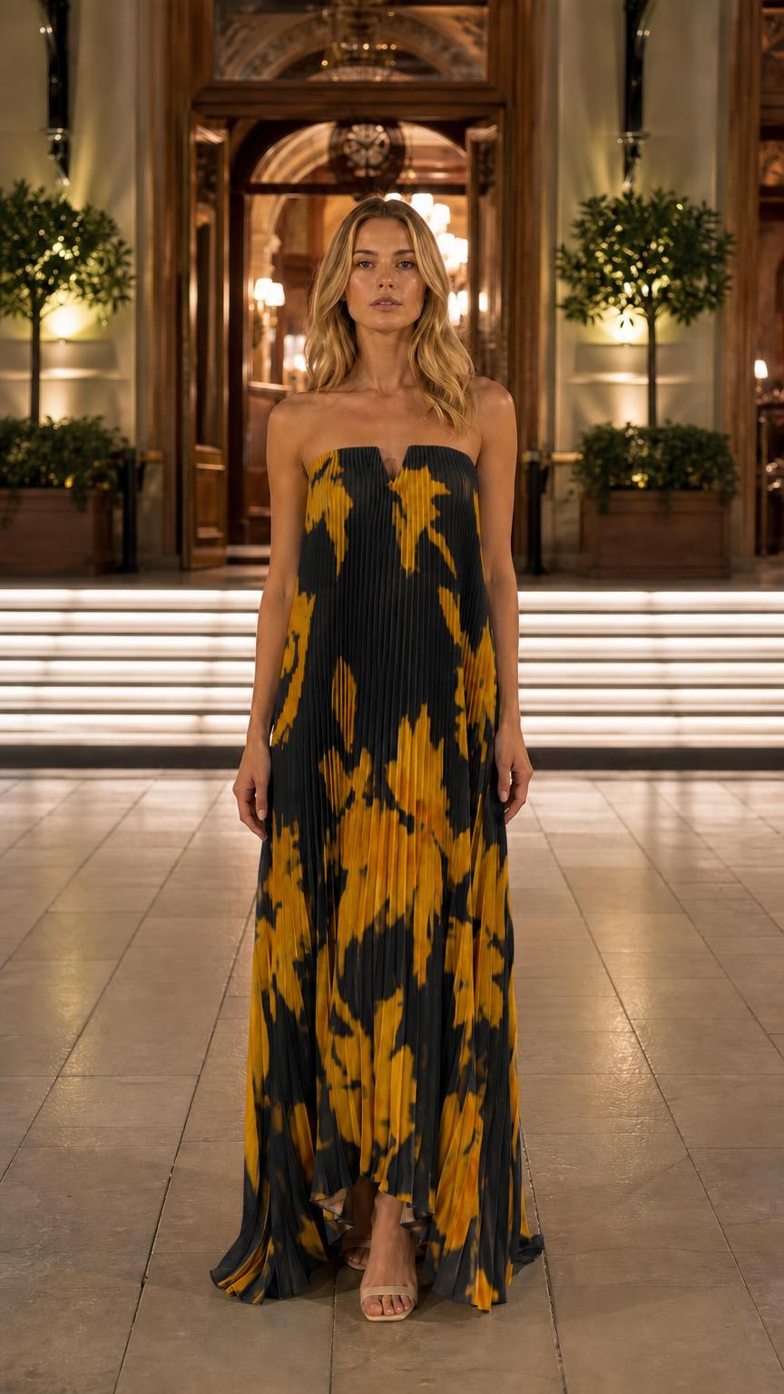 Front view of black floral pleated strapless maxi dress