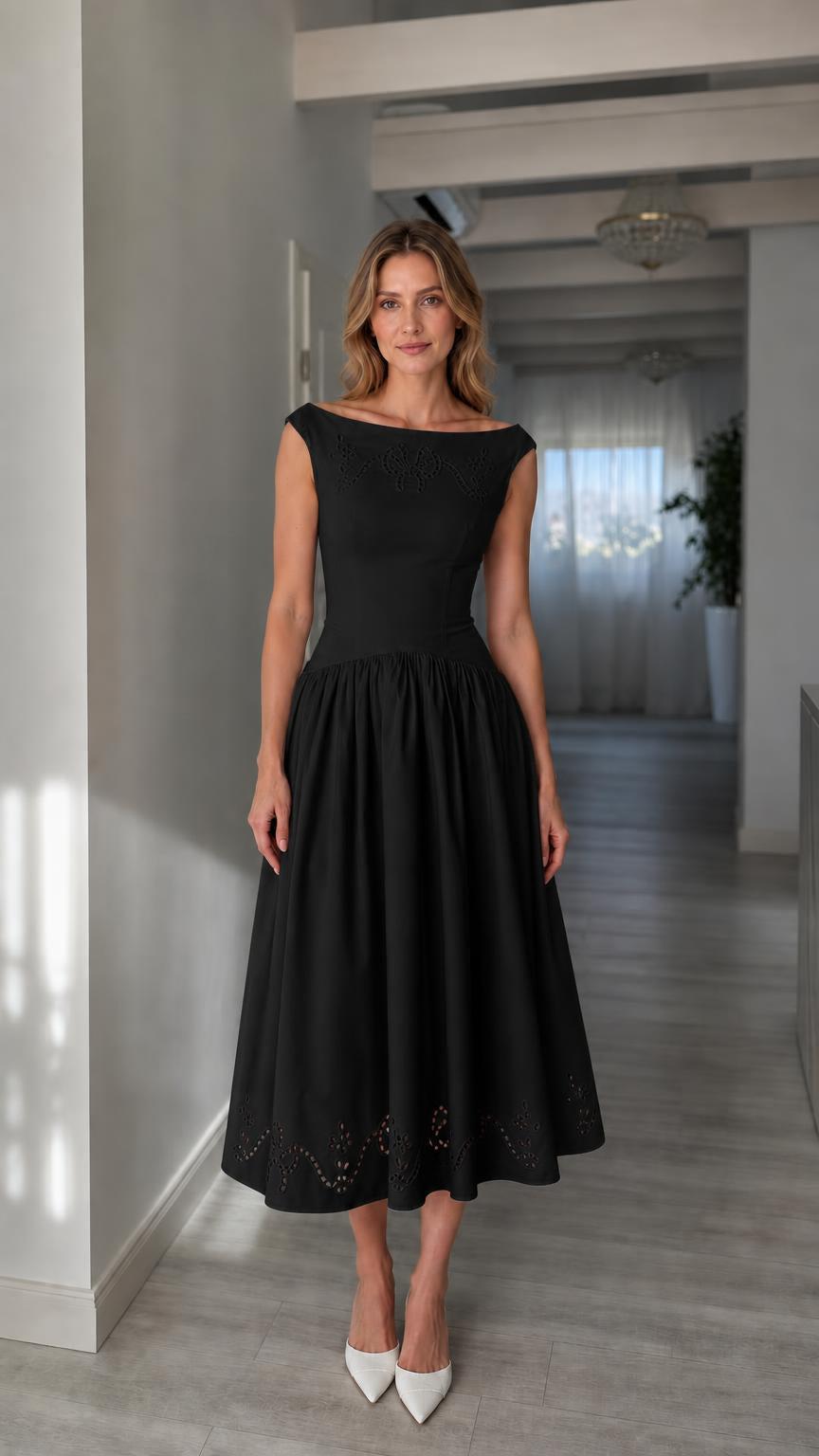 Full view of woman wearing black boatneck midi dress