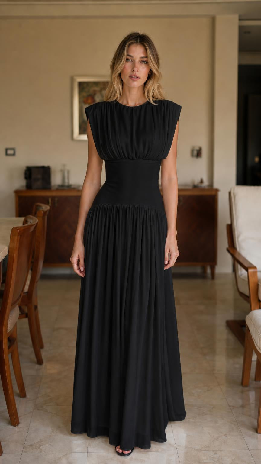 Front view of woman wearing black pleated maxi dress