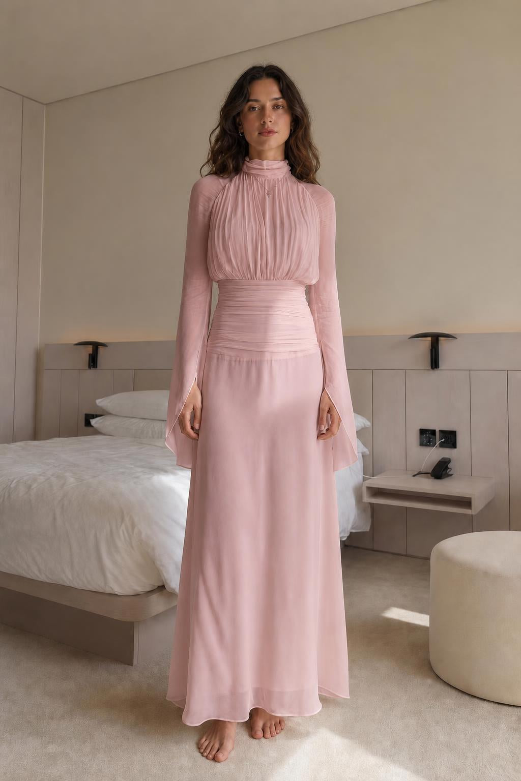 Front view of woman wearing blush pink pleated maxi dress