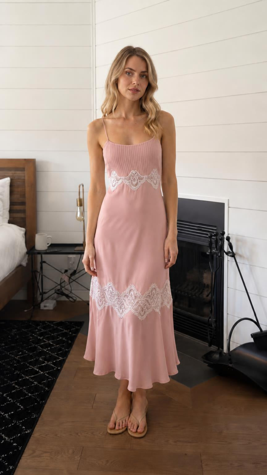 Woman wearing pink lace trim pleated slip midi dress