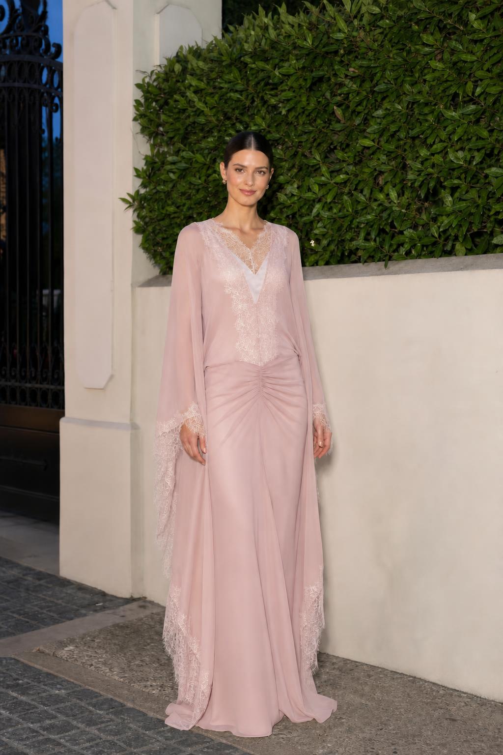 Model wearing dusty rose lace trim cape sleeve maxi dress