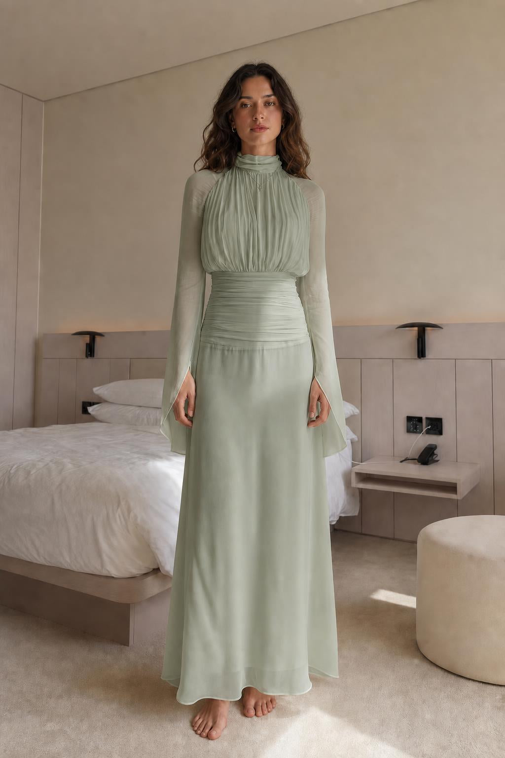 Front view of woman wearing sage green pleated maxi dress