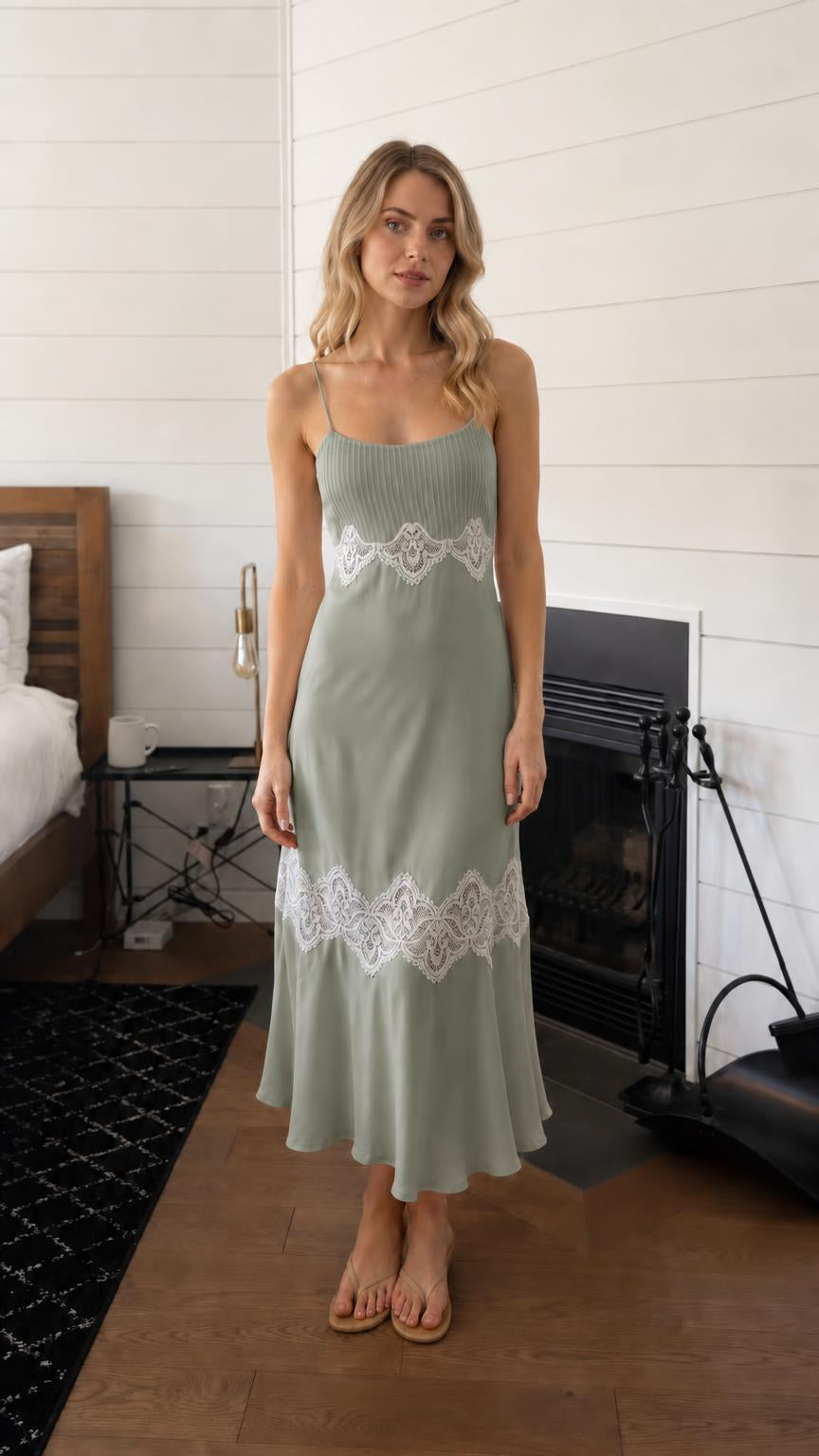 Woman wearing sage green lace trim pleated slip midi dress