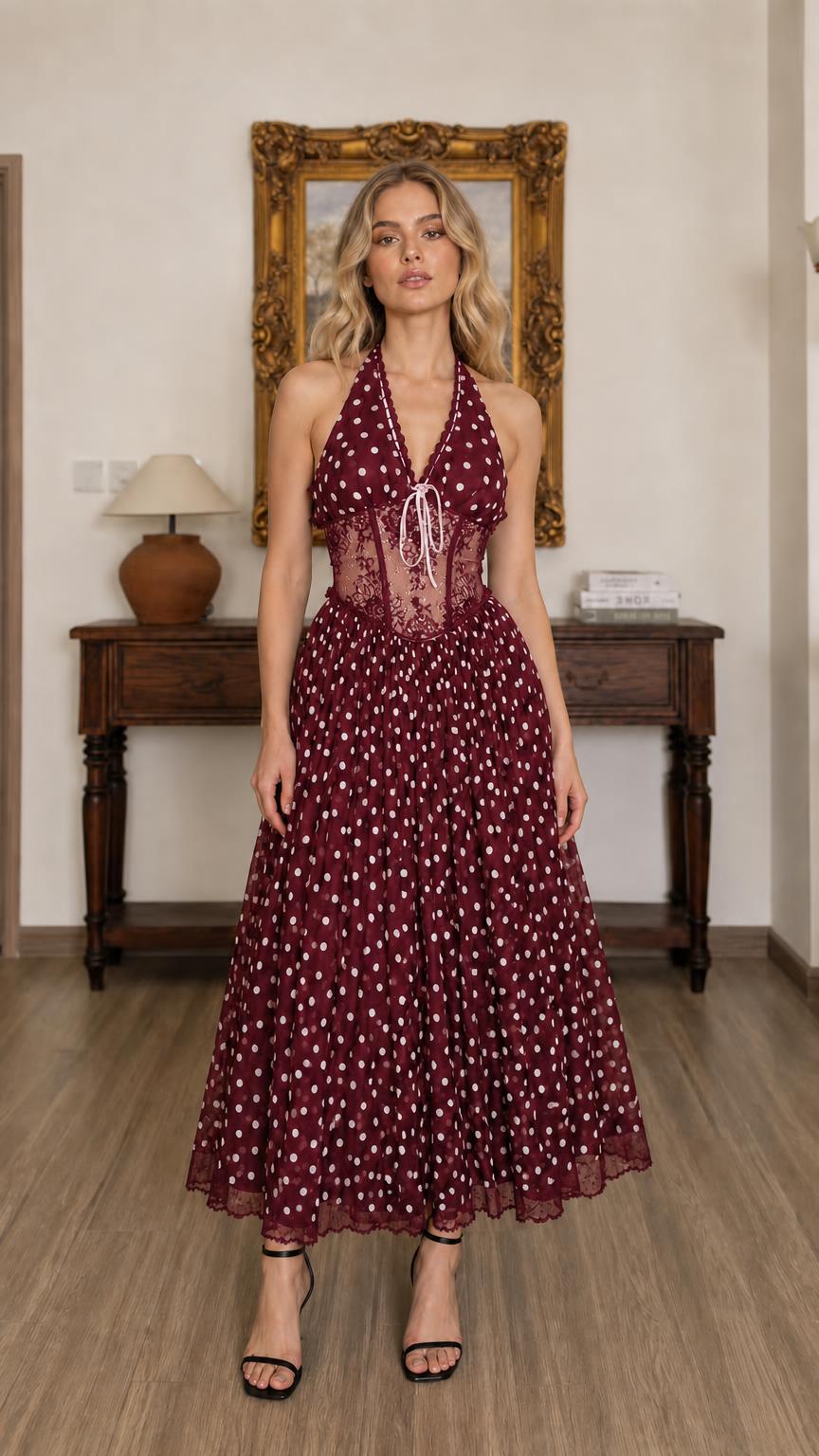 Front full view of burgundy polka dot halter midi dress on model