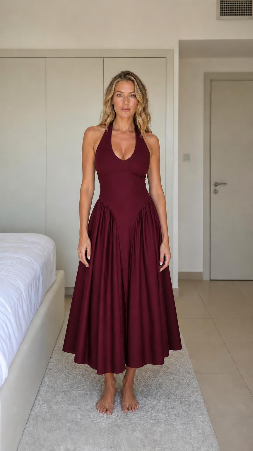 Front view of woman wearing burgundy halter neck midi dress