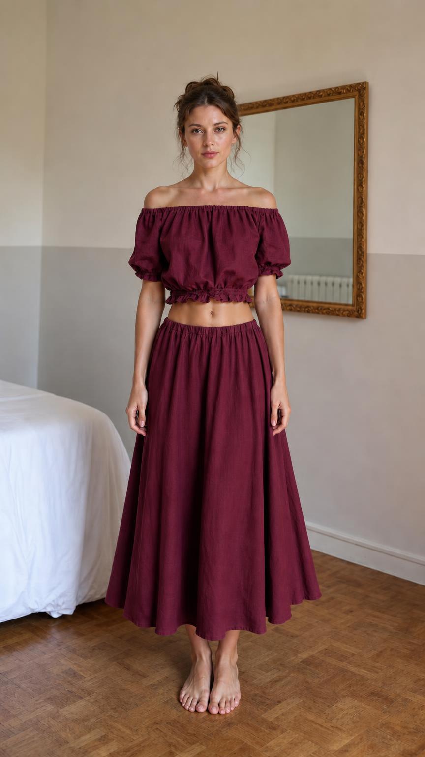 Front view of woman wearing burgundy off-shoulder crop top and midi skirt set