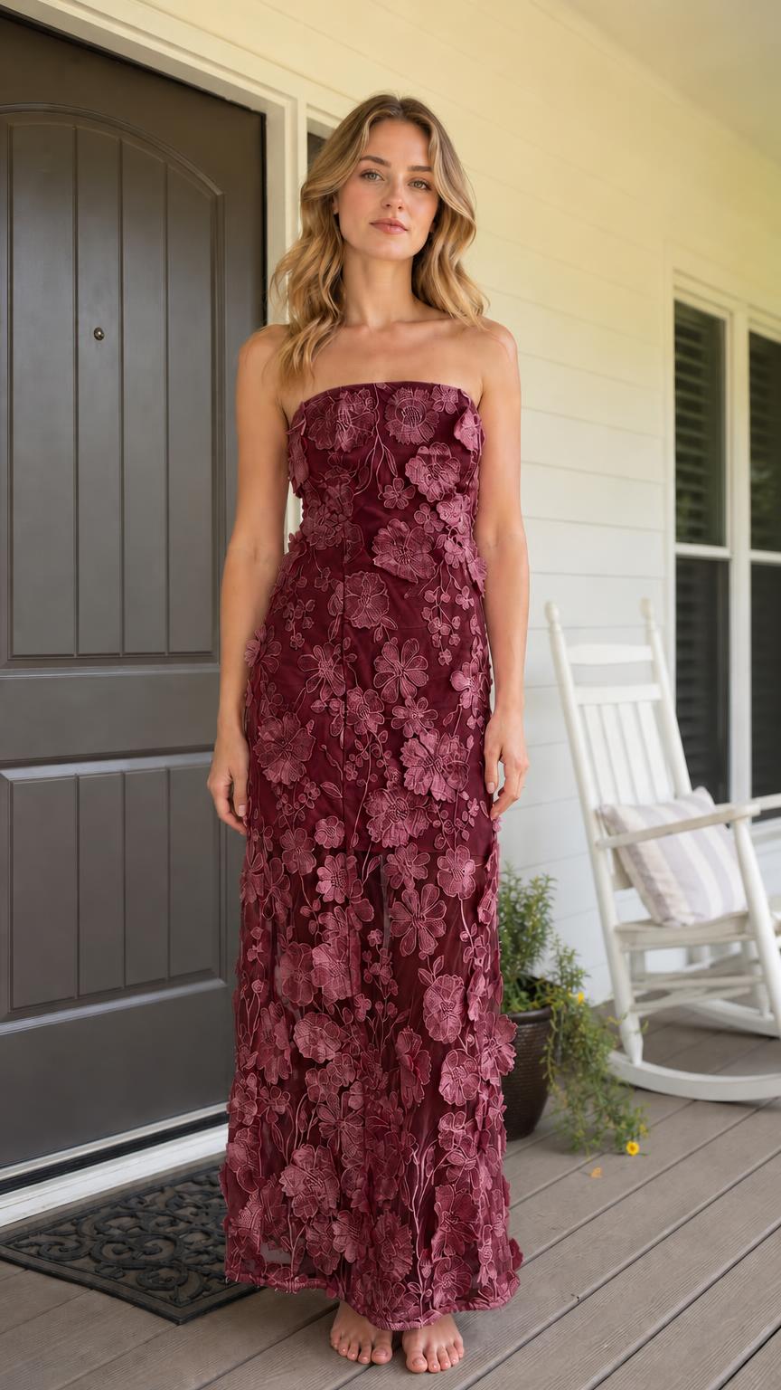 Front view of model wearing burgundy 3D floral strapless maxi dress