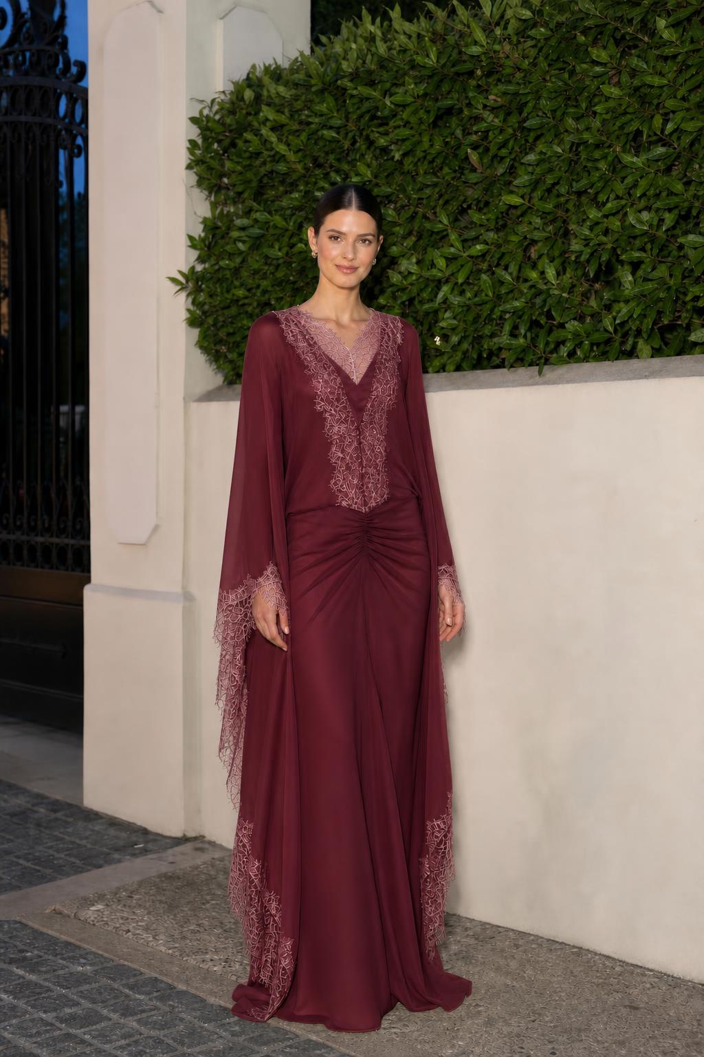 Model wearing burgundy lace trim cape sleeve maxi dress