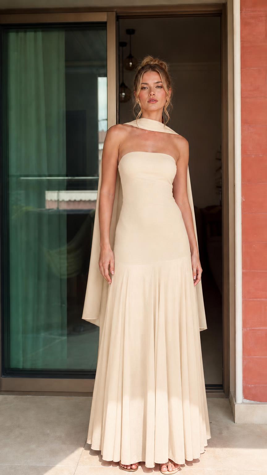 Front view of woman wearing beige strapless maxi dress