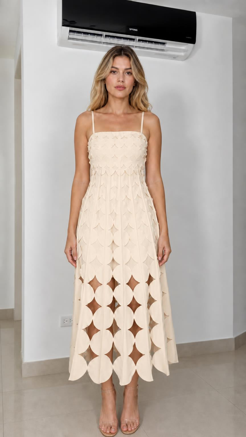 Front view of model wearing cream laser-cut geometric midi dress